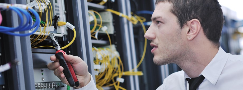 young engeneer in datacenter server room