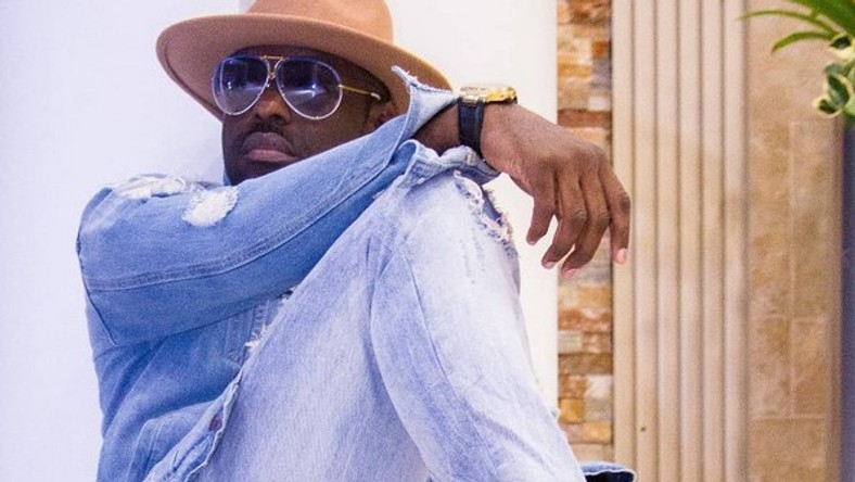 Image result for jim iyke sitting down with his bags