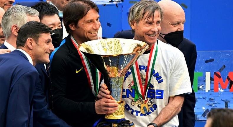 Inter Milan coach Antonio Conte (L) and team technical director Gabriele Oriali (R) hold the 'Scudetto' trophy. Creator: MIGUEL MEDINA