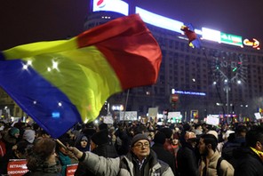 Protester waves Romanian flag during a demonstration in Bucharest