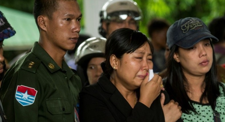 Khine Zin Win (C), who lost her youngest brother and his family, cries during the funeral in Dawei, Myanmar