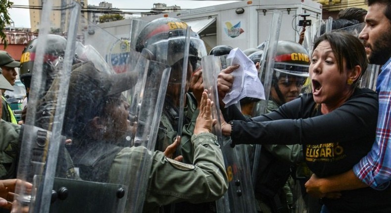 Venezuelan opposition deputy Amelia Belisario (2nd-R) scuffles with National Guard during a protest in front of the Supreme Court in Caracas