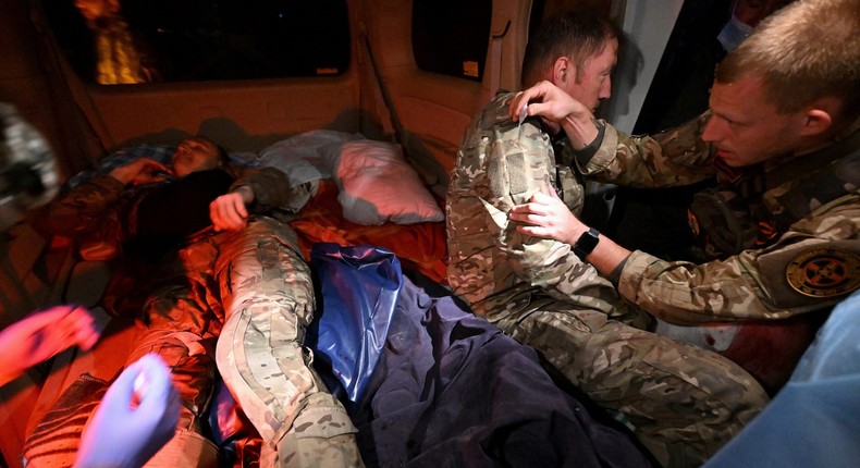 Medics provide assistance in a vehicle in Russia's Kursk region on Sunday.Kommersant Photo/Anatoliy Zhdanov via REUTERS