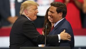 Then-President Donald Trump greets then-Florida Republican gubernatorial candidate Ron DeSantis during a campaign rally at the Hertz Arena on October 31, 2018 in Estero, Florida.
