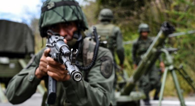 The Venezuelan military is undertaking a massive air, sea and land search for remnants of attackers the government described as mercenaries