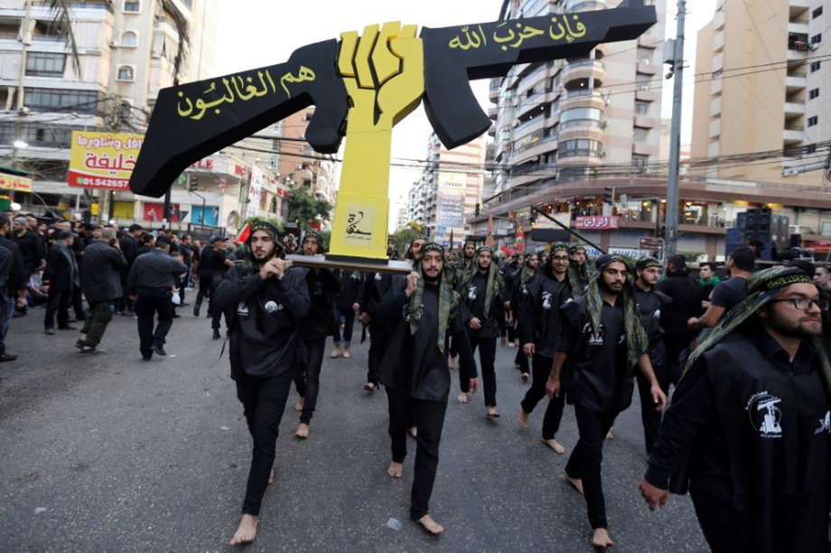Lebanese Hezbollah supporters carry a replica of a Hezbollah emblem during a religious procession to mark Ashura in Beirut's southern suburbs, October 12, 2016.