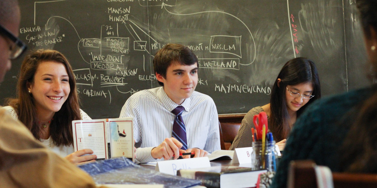 Students in class sit at the oval-shaped Harkness Table, the cornerstone of Phillips Exeter Academy's unique, student-centered teaching method.
