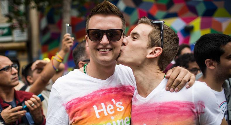 Kevin Lloyd, right, kisses his boyfriend, Breyer Conroy, left, in the San Francisco Gay Pride Parade, June 28, 2015 in San Francisco, California. The 2015 pride parade comes two days after the U.S. Supreme Court's landmark decision to legalize same-sex marriage in all 50 states.