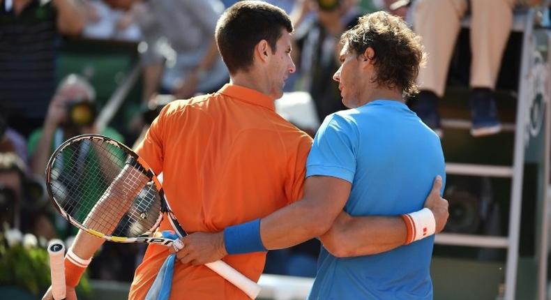 Rafael Nadal (right) and Novak Djokovic embrace at the end of their quarter-final at the 2015 French Open