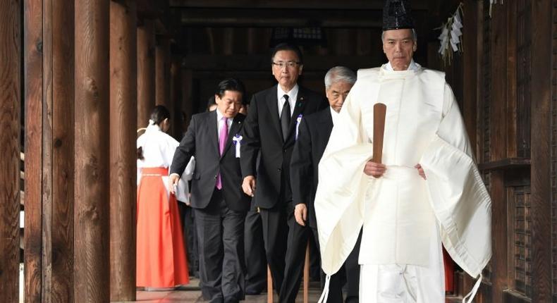 A Shinto priest (R) leads a group of lawmakers at Yasukuni Shrine in Tokyo, on October 18, 2016