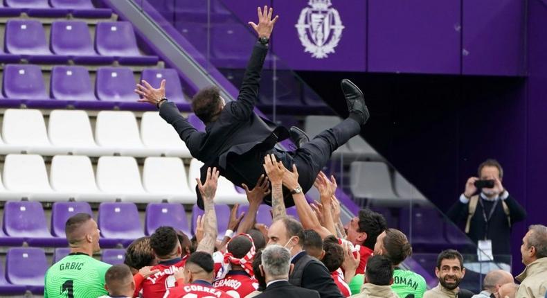 Flying high: Atletico Madrid players toss coach Diego Simeone to celebrate their Liga title Creator: CESAR MANSO