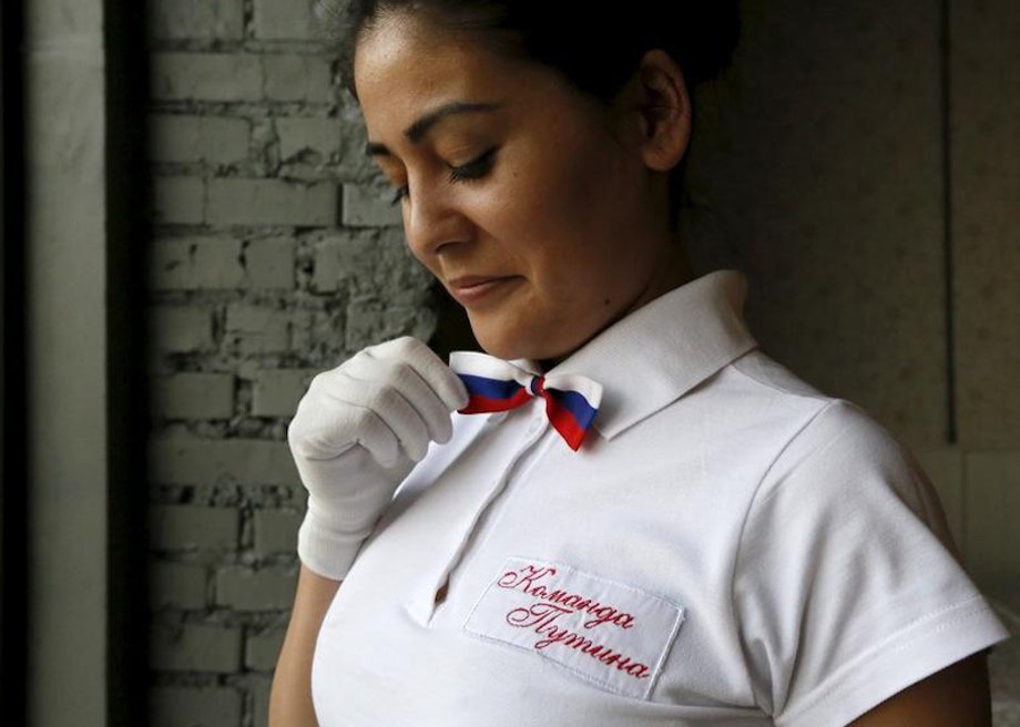 A waitress straightens a bow tie in the colors of the Russian national flag at the "President Cafe" in Krasnoyarsk, Siberia, Russia, April 7, 2016.