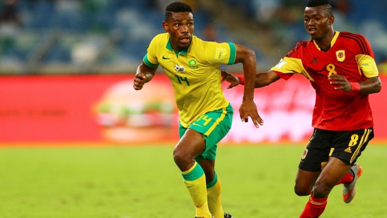 Thulani Hlatshwayo (L), captain of South African Premiership leaders Bidvest Wits FC, in action for the national team against Angola