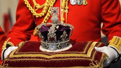 The Imperial State Crown is carried in for Britain's Queen Elizabeth during the annual State Opening of Parliament