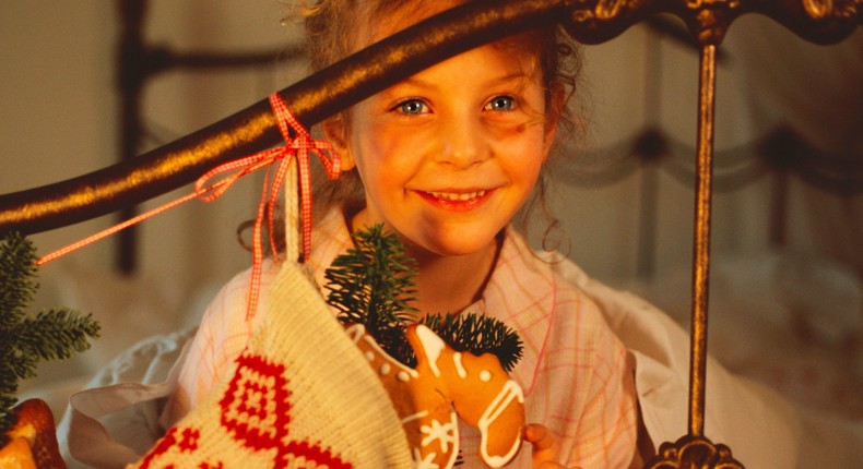 Some British children hang Christmas stockings at the ends of their beds.Altrendo Images/Getty Images