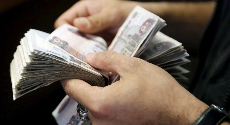 A customer counts his Egyptian 50 pound notes at an exchange office in downtown Cairo, Egypt, April 19, 2016. REUTERS/Amr Abdallah Dalsh