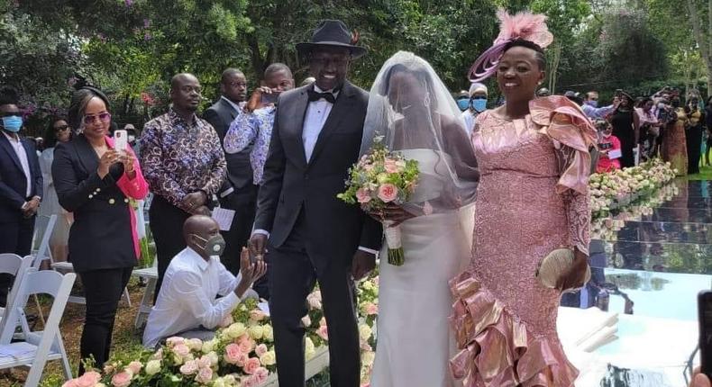 Deputy President William Ruto and wife Rachel walk June Ruto on the aisle at her wedding