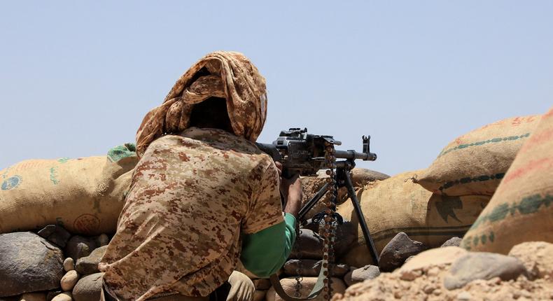 A fighter with forces loyal to Yemen's Saudi-backed government holds a position against Huthi rebels in Yemen's northeastern province of Marib, on April 6, 2021.

