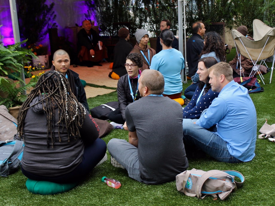 Dreamforce attendees sit in conversation with one of the monks at Dreamforce on Wednesday.
