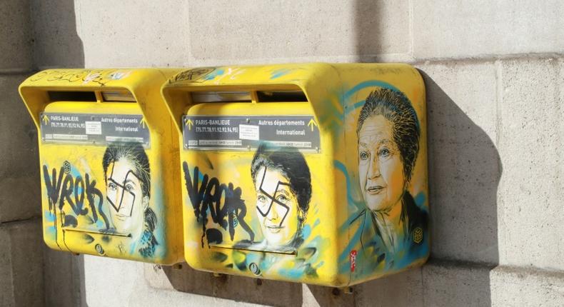 French society is in trouble, the son of the late Simone Veil said as he looked at the swastikas daubed on two post boxes decorated with pictures of his mother, a Holocaust survivor