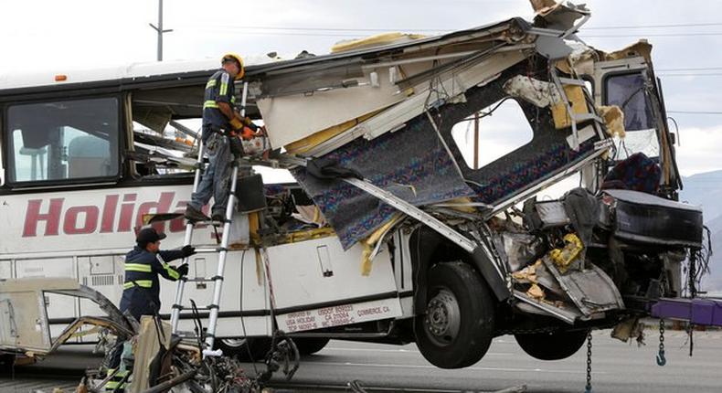 Workers cut away debris from the front of a bus involved in a mass casualty crash on the westbound Interstate 10 freeway near Palm Springs, California October 23, 2016. 