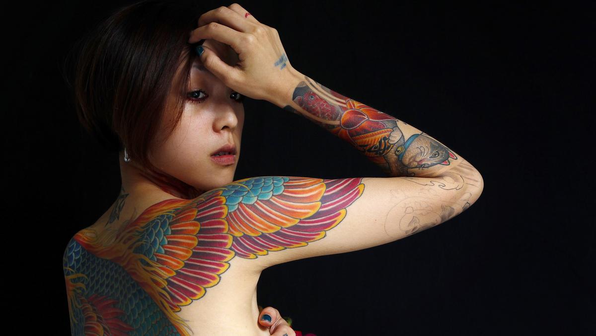 Nai, whose husband is a tattoo artist, poses for a portrait with Reuters during the 2010 Taiwan International Tattoo Convention in Taipei