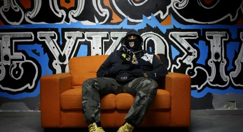 A member of the APOEL ultras, supporting Nicosia's football team of the same name, sits at their fan club headquarters in the Cypriot capital