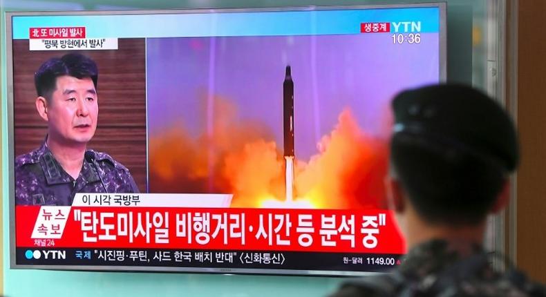 A South Korean soldier watches a television news showing file footage of a North Korean missile launch, at a railway station in Seoul on July 4, 2017