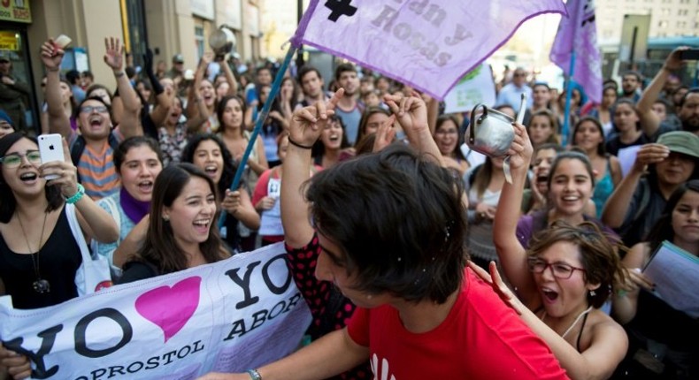 Activists (back) in favor of abortion argue with an activist (in red) who is against it, during demos in Santiago, in 2016