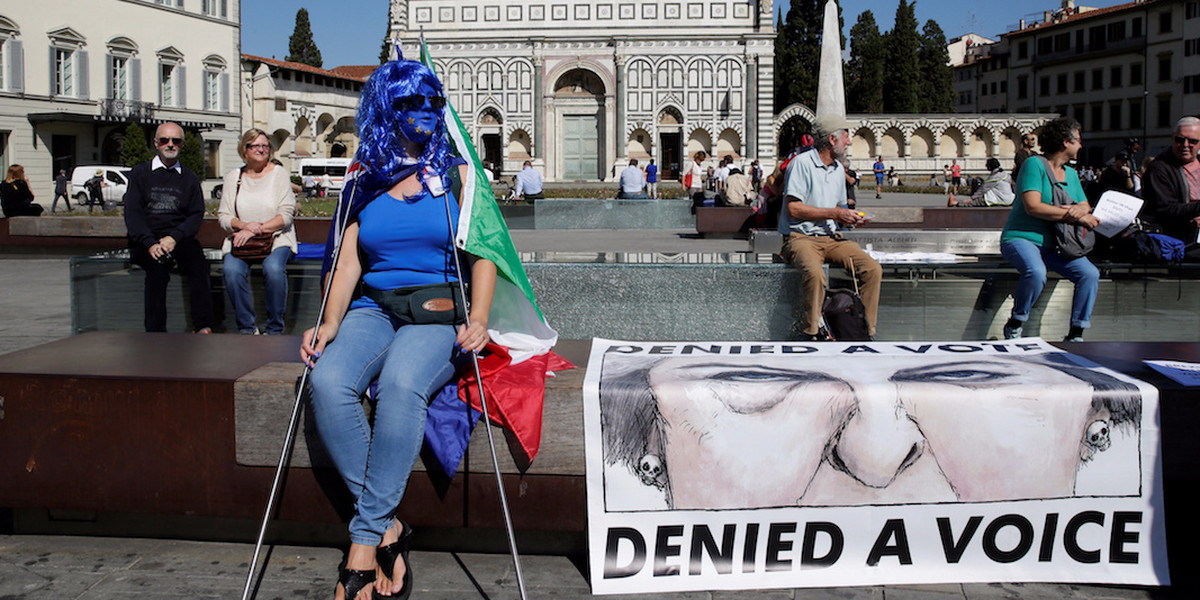 Protester waits in Florence for May's speech.