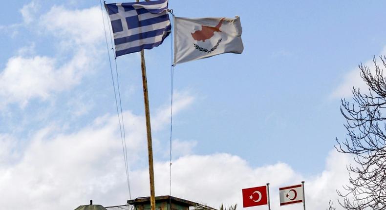 The flags of Greece, Cyprus, Turkey and the self-proclaimed Turkish Republic of Northern Cyprus (TRNC) fly above security outposts in the divided Cypriot capital Nicosia