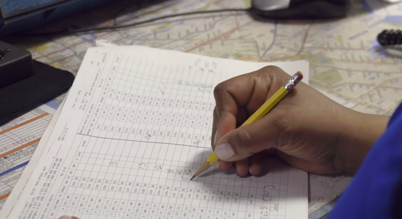 An MTA employee tracks trains by hand