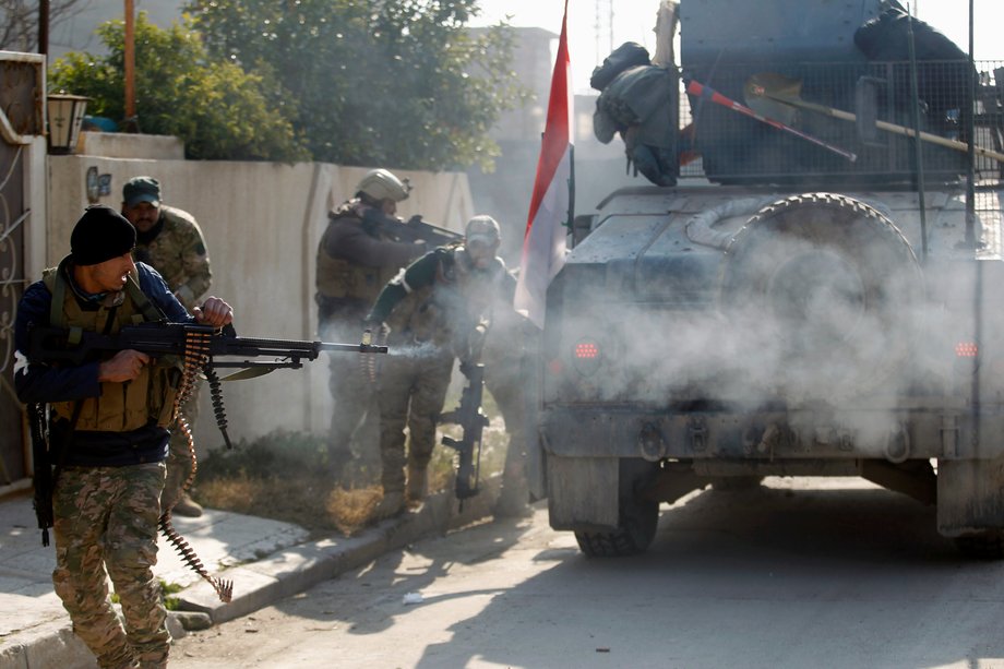 Members of the Iraqi rapid-response forces clashing with ISIS militants in the Mithaq district of eastern Mosul on January 5.