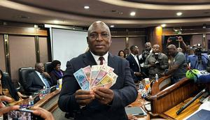 John Mushayavanhu, Governor of the Reserve Bank of Zimbabwe, presents the new national currency Zimbabwe Gold, or ZiG.Columbus Mavhunga/picture alliance/Getty Images