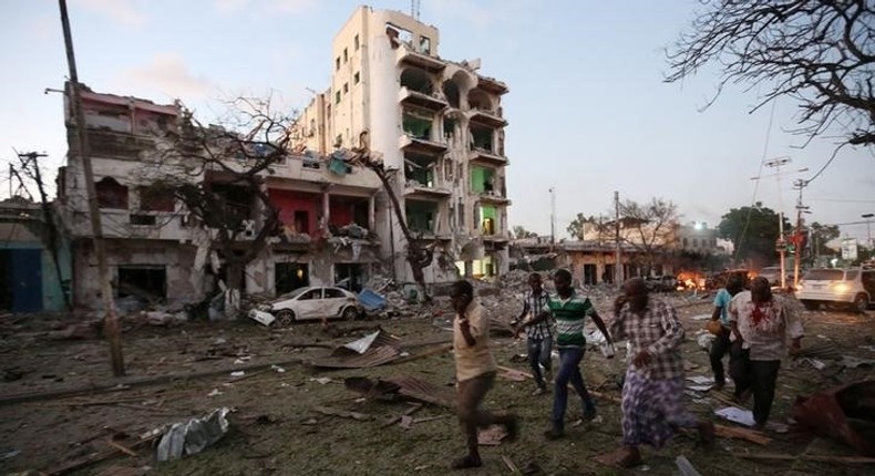 Civilians evacuate from the scene of a suicide car bombing outside Hotel Ambassador on Maka Al Mukaram Road in Somalia's capital Mogadishu, June 1, 2016. 