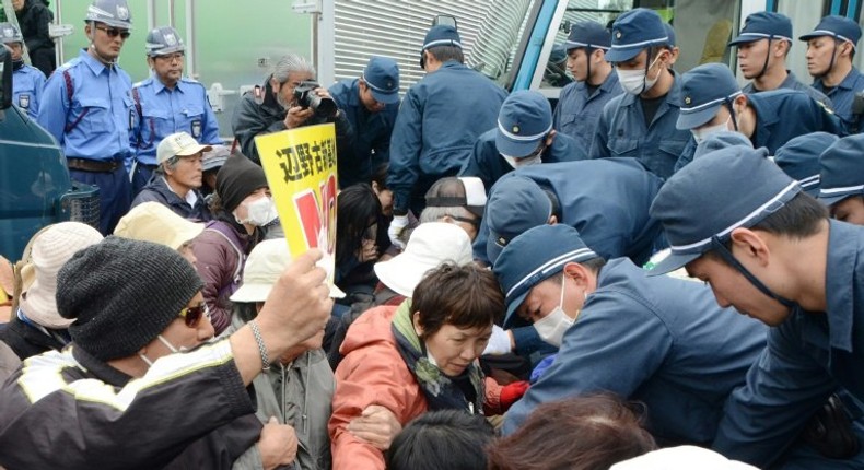 Japanese protesters demonstrate outside US Marine Camp Schwab on February 6, as they protest against the construction of a controversial new US airbase on Okinawa