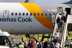 Passengers board a Thomas Cook airplane at the Heraklion airport on the island of Crete