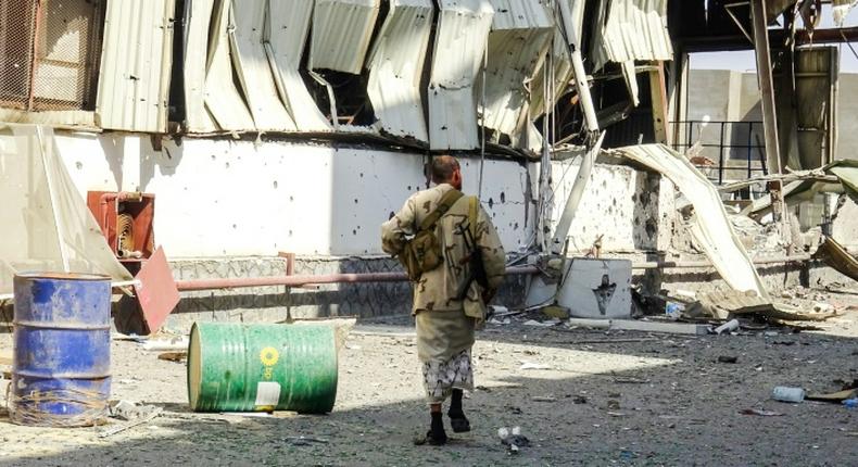 Yemeni pro-government forces walk through destruction in the port city of Hodeida in November 2018: the UN is calling on both sides to honor an agreement to pull out of key ports including Hodeida