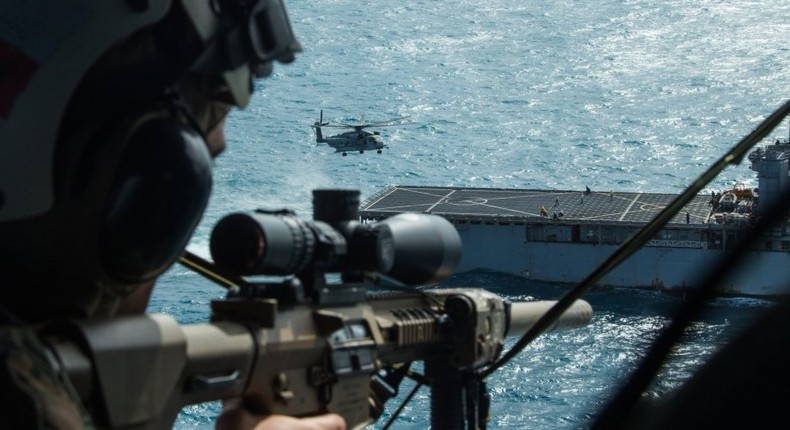 A lead scout sniper with the 31st Marine Expeditionary Units Maritime Raid Force, provides aerial sniper coverage during a simulated visit, board, search and seizure training mission.