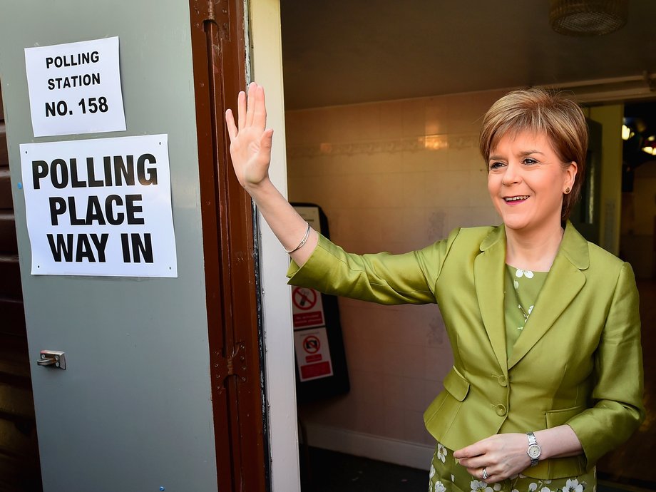 First Minister of Scotland and leader of the SNP Nicola Sturgeon, votes with her husband Peter Murrell on May 7, 2015 in Glasgow, Scotland.