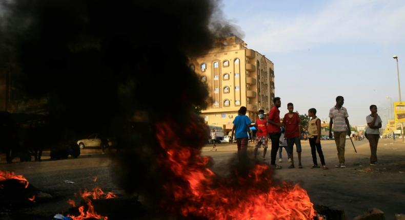 Demonstrators burn tires in the middle of a main street in Khartoum on July 27, 2019, as they protest against the results of the probe into the June raid on a Khartoum protest camp revealed.Demonstrators and rights groups had accused the paramilitary Rapid Support Forces of carrying out the crackdown, a charge denied by the group's powerful chief, General Mohamed Hamdan Daglo. But a joint probe by prosecutors and the ruling military council revealed on Saturday that RSF paramilitaries were involved in the raid.