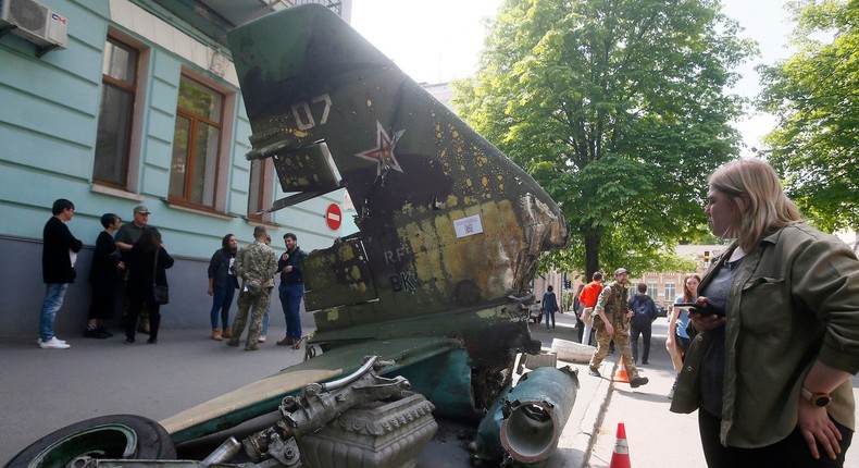 Ukrainians look on a part of destroyed Russian Su-25 on display in Kyiv on May 8, 2022.STR/NurPhoto via Getty Images