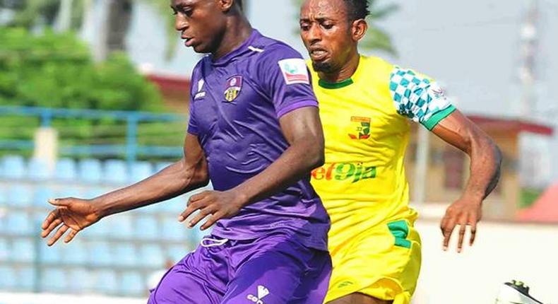 Stephen Odey, the league's highest goal scorer shielding the ball from a Plateau United player 