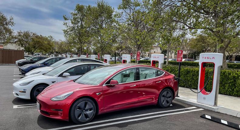 Tesla electric cars charge at a Supercharger.George Rose/Getty Images