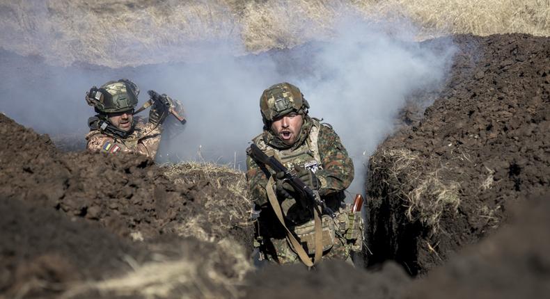 Two Ukrainian soldiers training in trenches at an undisclosed location in Ukraine's Donetsk Oblast, on February 27, 2024.Narciso Contreras/Anadolu via Getty Images