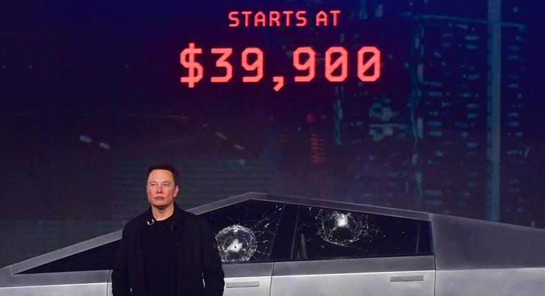 Tesla co-founder and CEO Elon Musk stands in front of the all-electric battery-powered Tesla's Cybertruck.