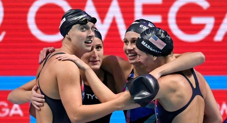 USA's Katie Ledeck (L), hugs her teammates as they celebrate their winning the women's 4x200m freestyle relay at the world championships, giving Ledecky the 13th world title of her career