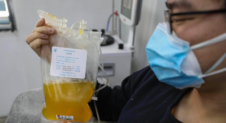 FILE - In this Feb. 18, 2020, file photo, Dr. Zhou Min, a recovered COVID-19 patient who has passed his 14-day quarantine, donates plasma in the city's blood center in Wuhan in central China's Hubei province. Plasma from recovered COVID-19 patients contains antibodies that may help reduce the viral load in patients that are fighting the disease. (Chinatopix via AP, File)