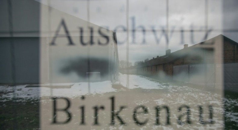 Barracks are seen through a poster at the former German nazi camp in Oswiecim (Auschwitz), Poland, on December 2, 2016, where US congressman Clay Higgins filmed and published a video deemed insensitive by Poland's chief rabbi