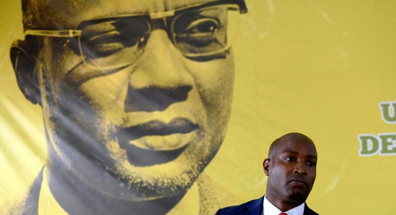 The founder of Guinea-Bissau's PAIGC party, Amilcar Cabral, looks down as spokesman Joao Bernardo Vieira speaks to the press